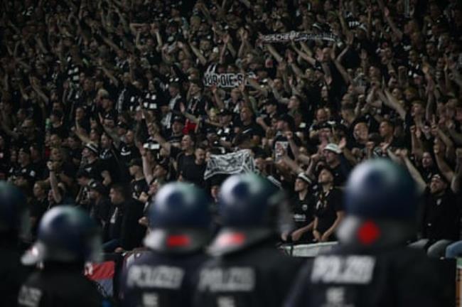 Riot police keep an eye on Frankfurt fans after a match against RB Leipzig.